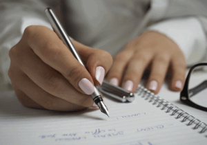 Woman holds a pen working on safety plannin